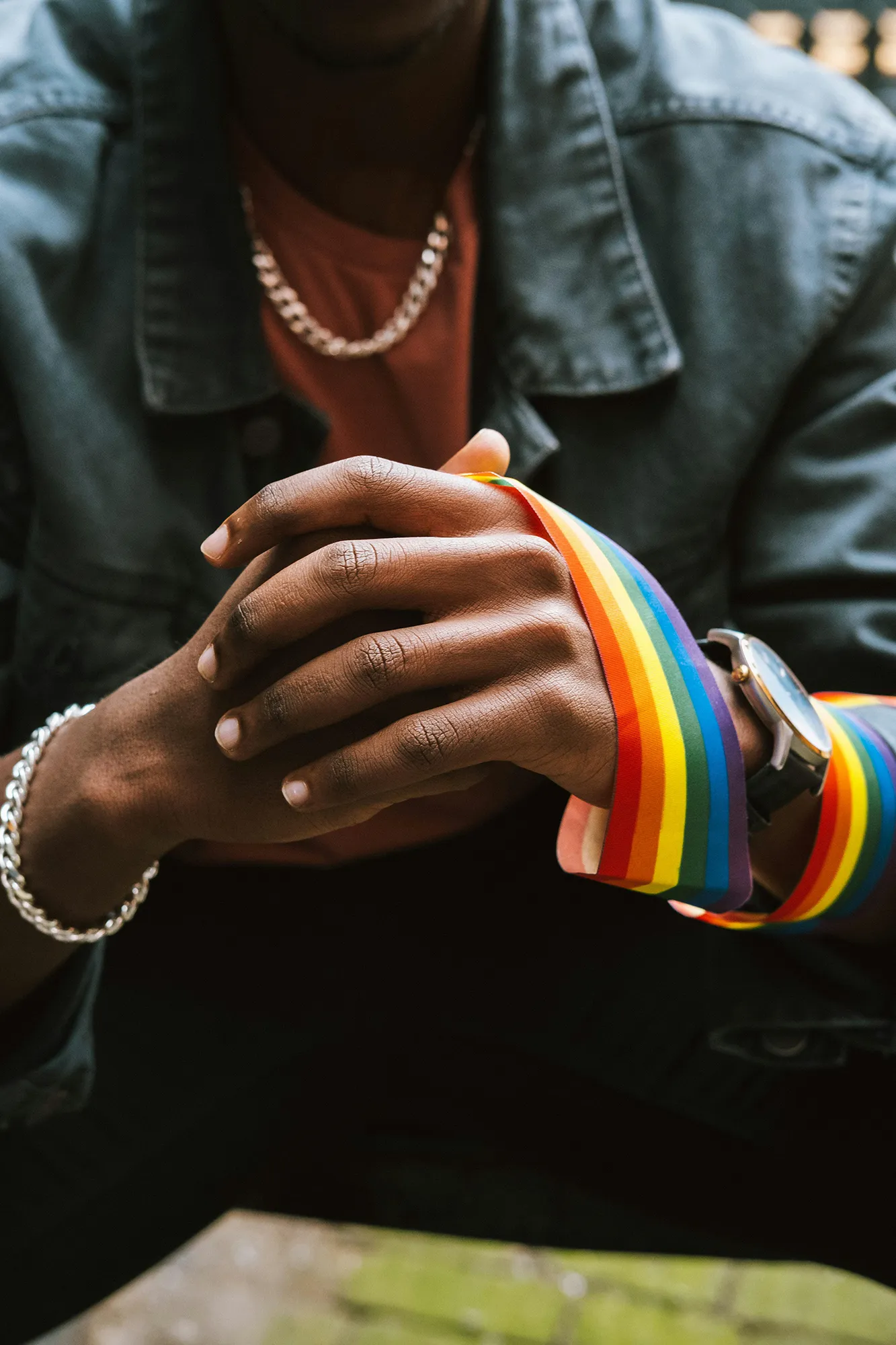 Office meeting with three people in front of a rainbow working at a desk.