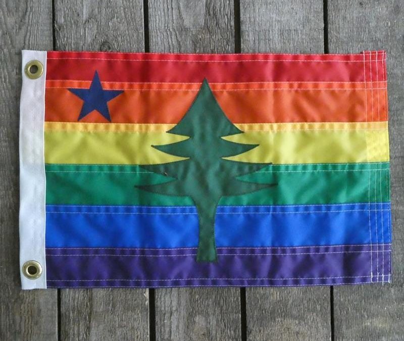 Rainbow pride flag with the Maine state flag pine tree emblem.