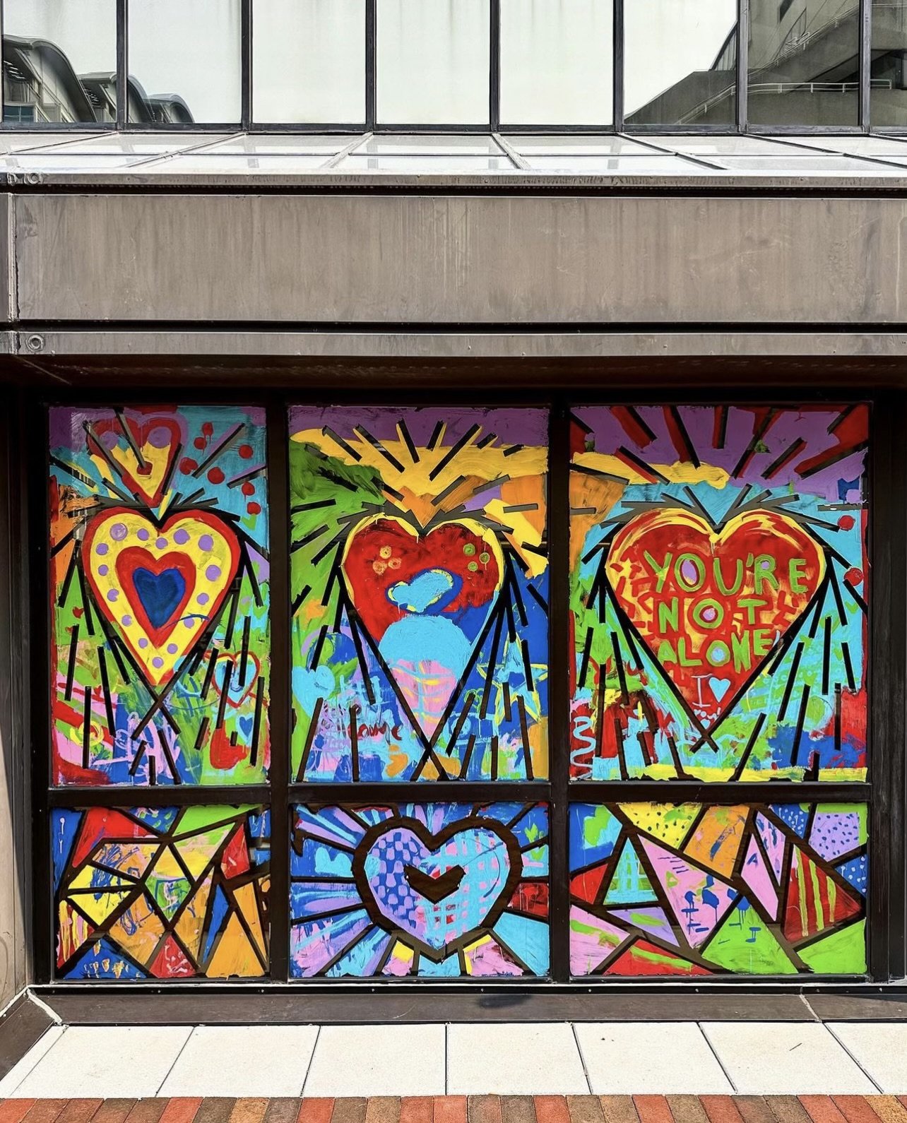 Vibrant mural featuring hearts and abstract geometric shapes in primary colors.